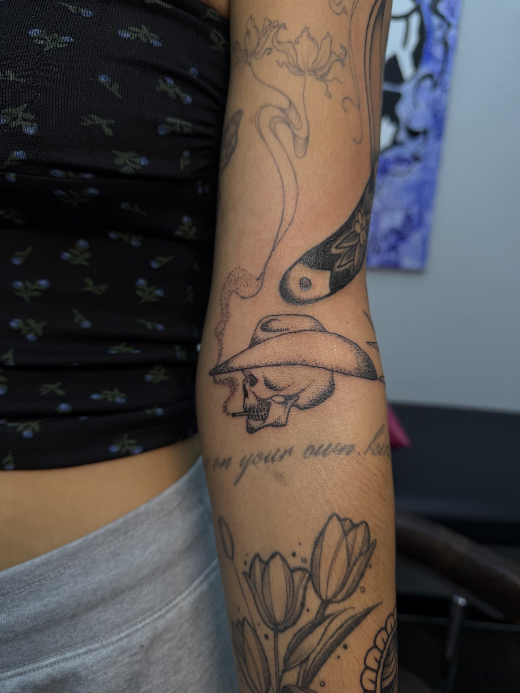 Cowboy skull arm sleeve with tulips and lettering — black and grey