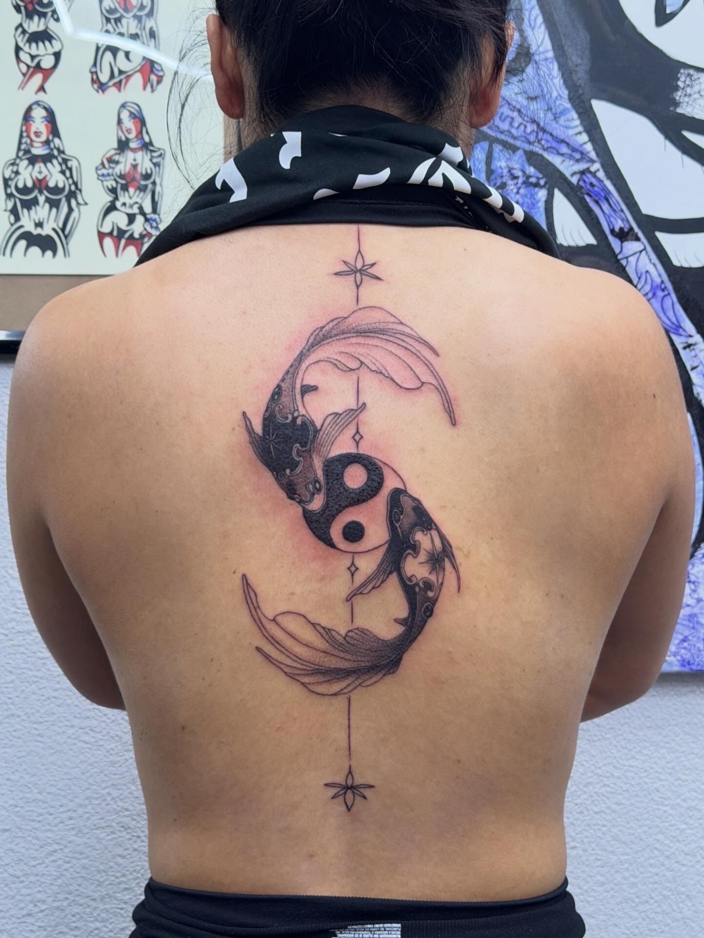 Black-ink yin-yang koi back piece, fine-line, by Will at COLDBLOOD Tattoo Studio